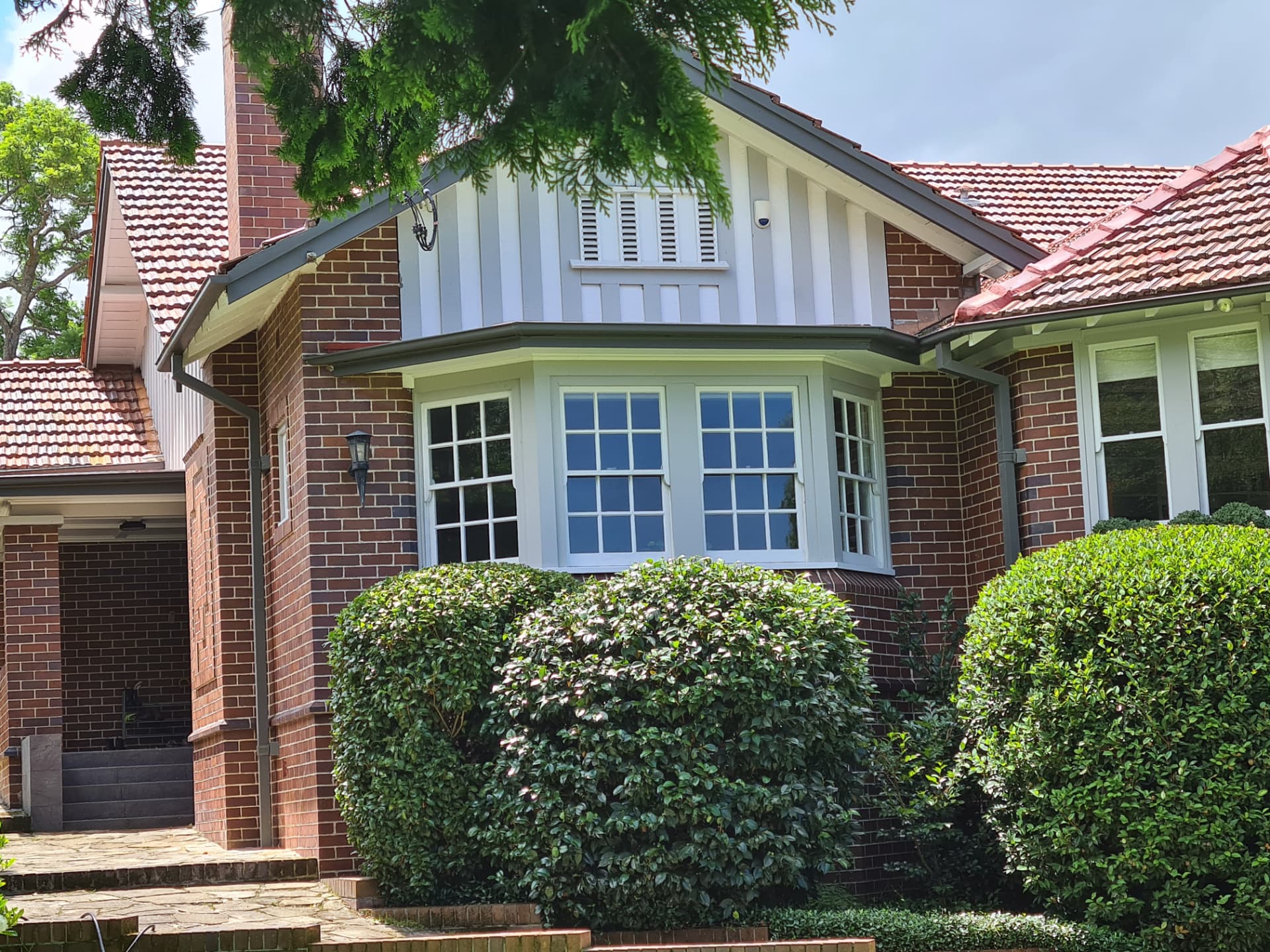 Older brick home with restored brickwork and sandstone base