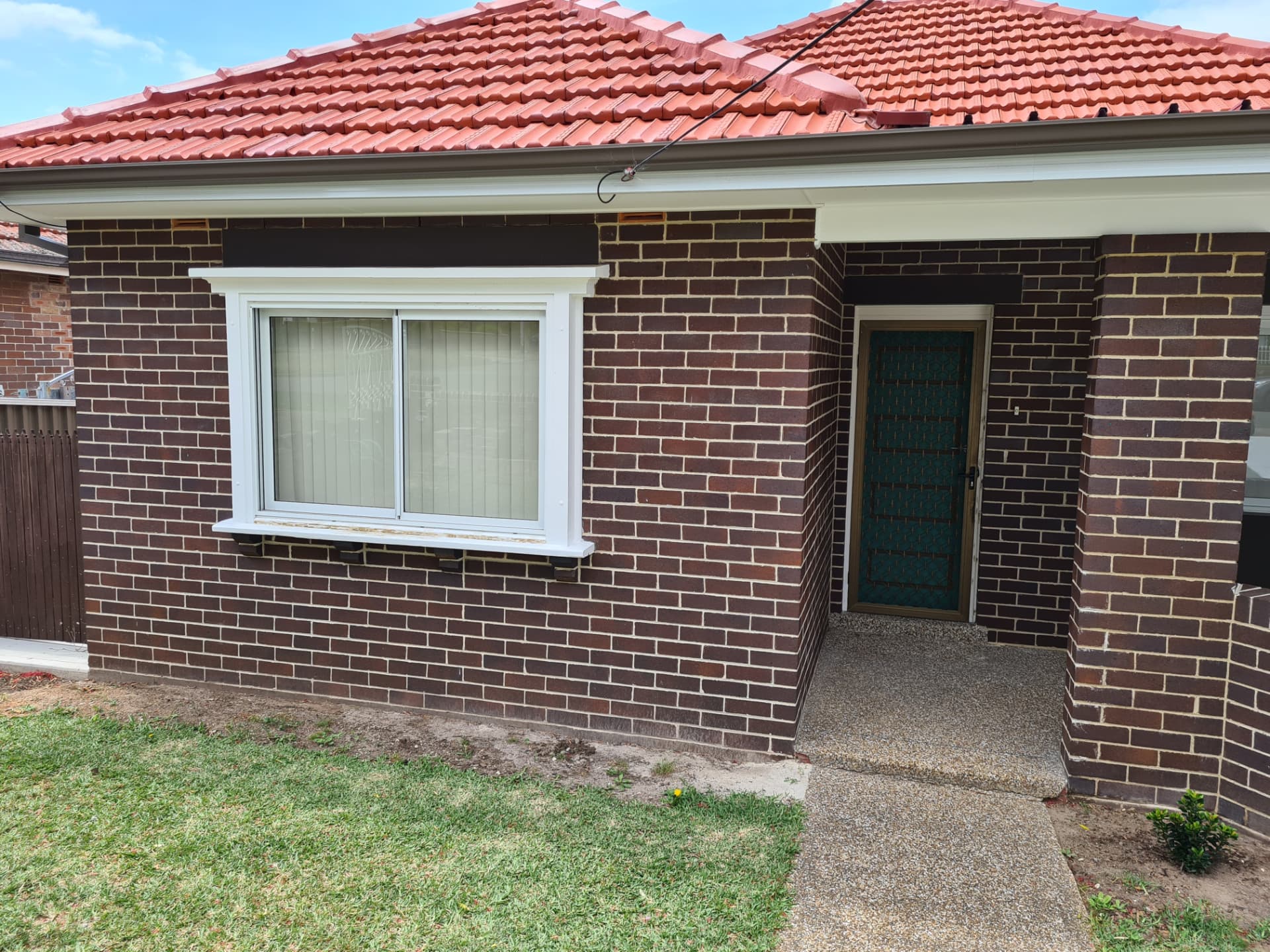 Restored mortar joints across the front elevation of a brick home
