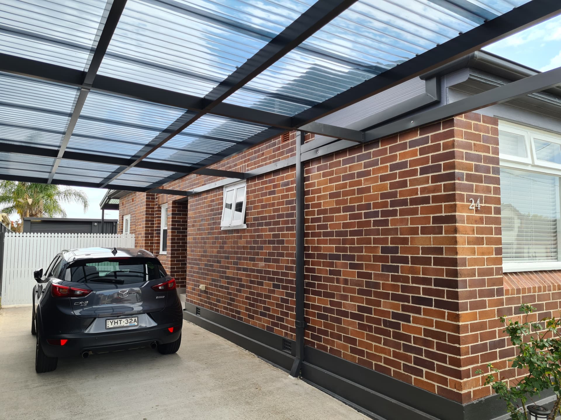 Repointed brickwork along a carport wall of an existing home