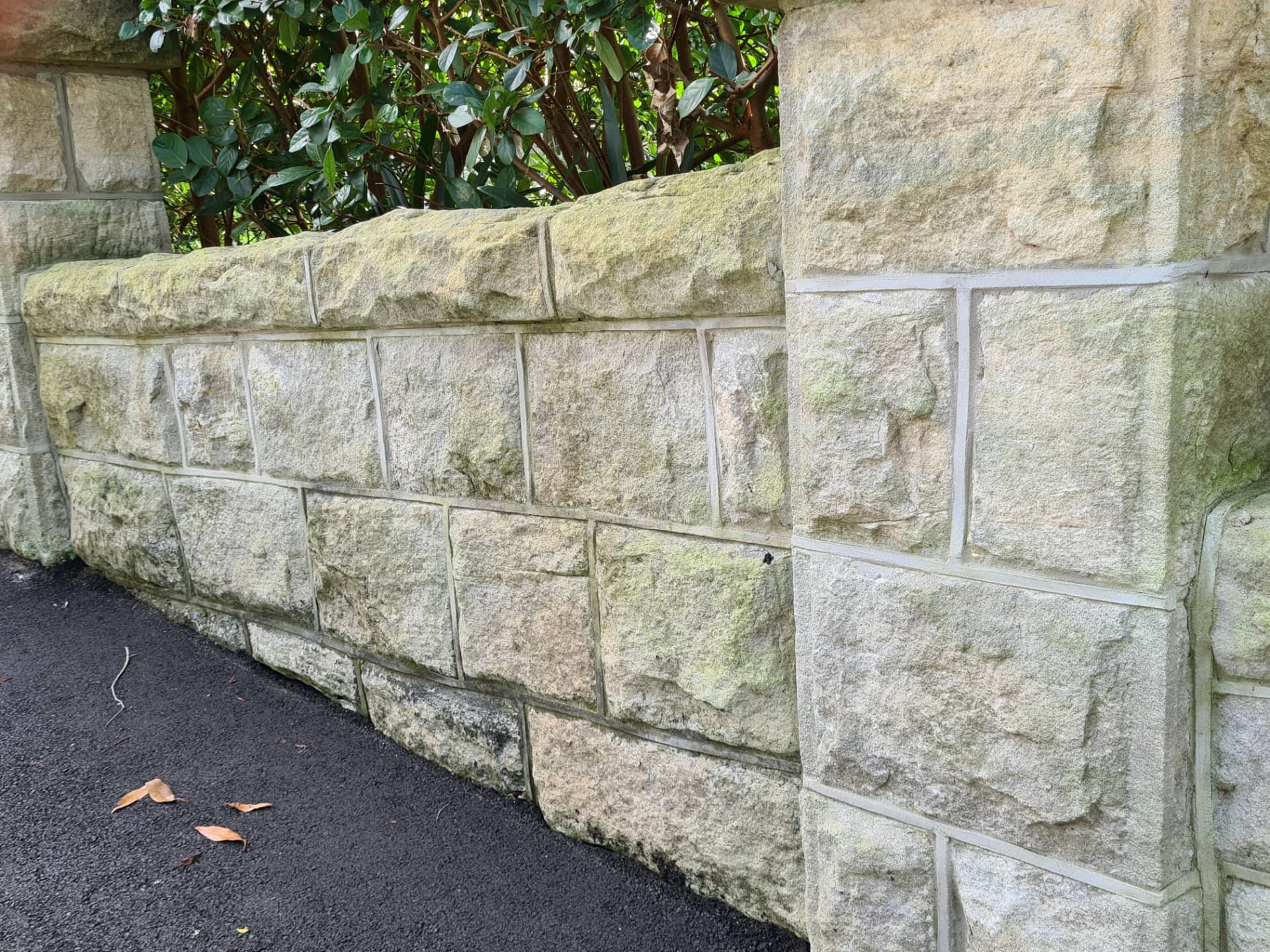 Weathered and stained sandstone masonry before restoration
