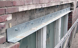 Rusted lintel above a window before repair and after replacement