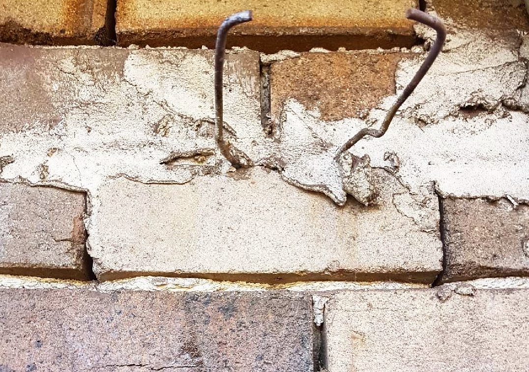 Corroded wall ties exposed in an existing cavity brick wall