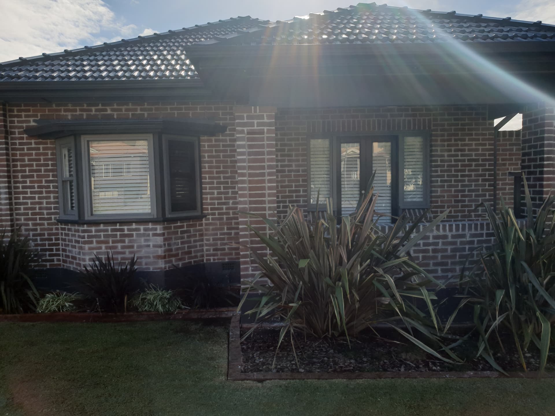 Older Sydney brick home with weathered brickwork before restoration