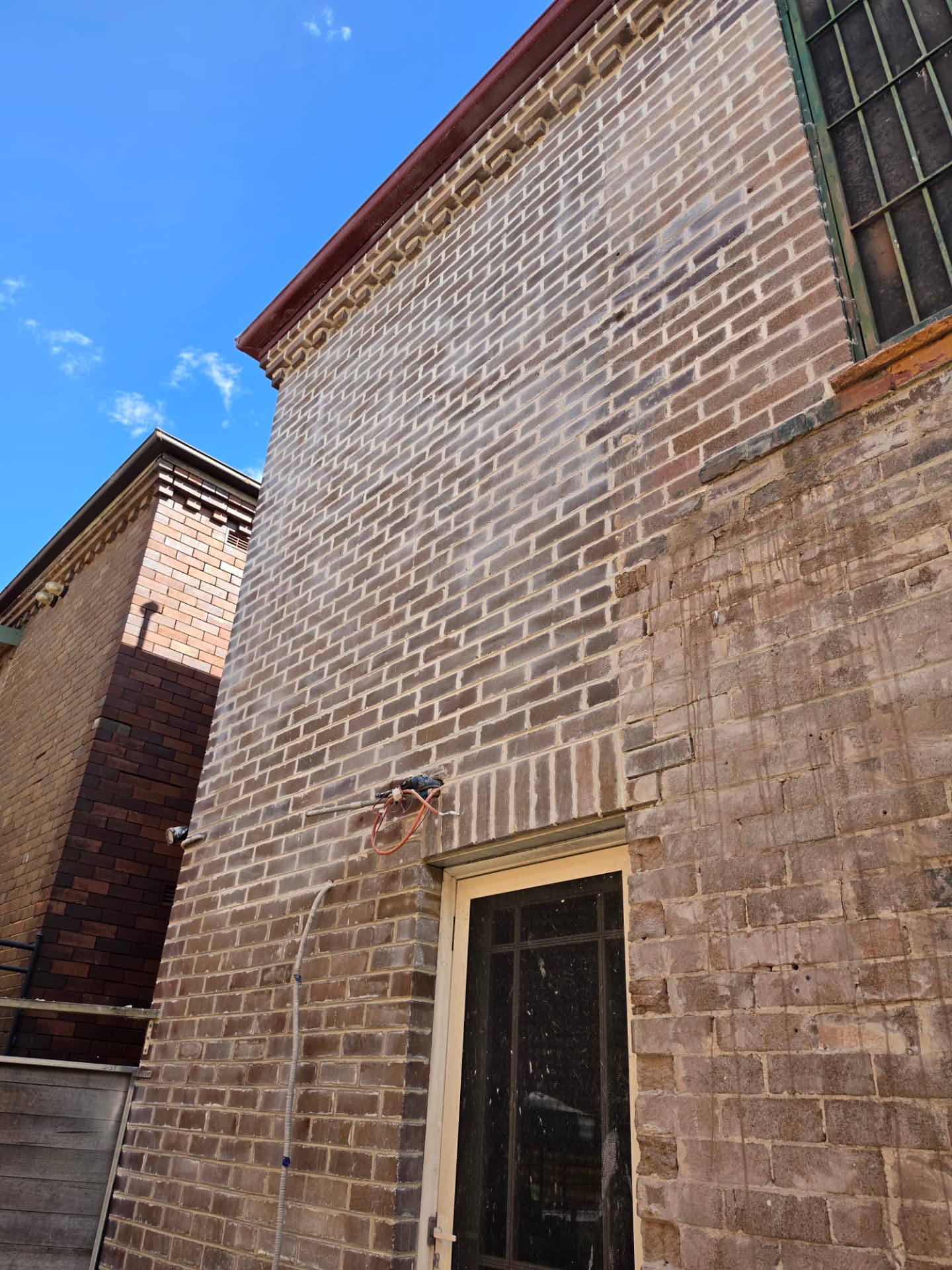Tall brick elevation showing newly repointed mortar joints