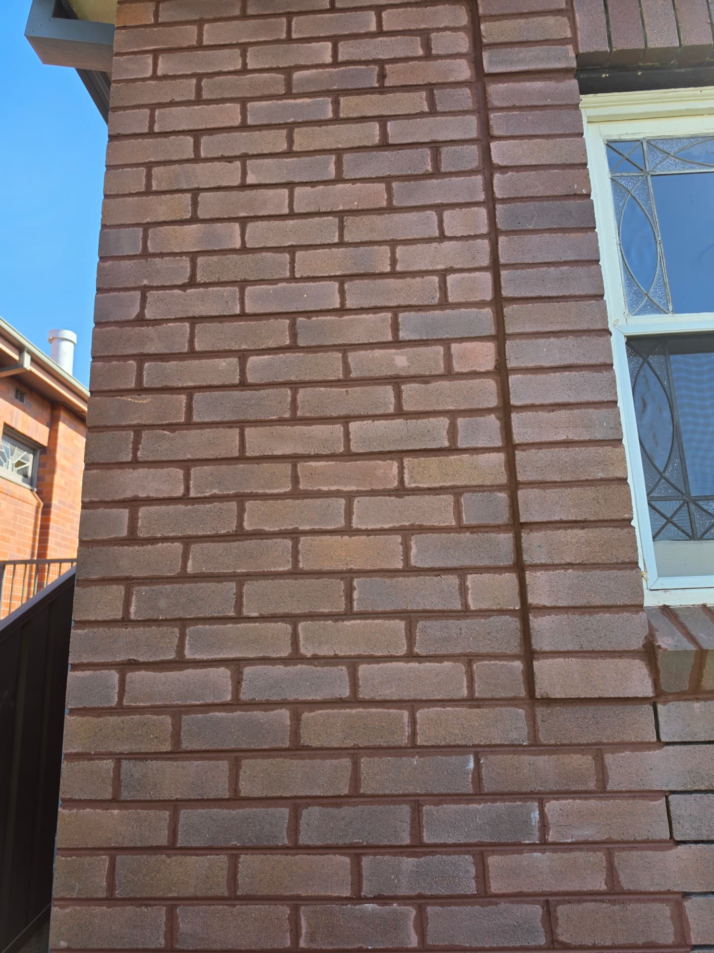 Close view of freshly repointed red brick mortar joints